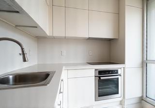 Empty, clean apartment kitchen ready for inspection.